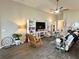 Spacious living room with comfortable seating, stylish decor, and a ceiling fan for added comfort at 7 Polermo Ave, St Cloud, FL 34771