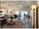 Open-concept living area featuring modern furnishings, vaulted ceiling, and a seamless flow to other spaces at 7 Polermo Ave, St Cloud, FL 34771