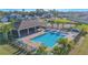 Aerial view of a community pool with palm trees and lounge chairs at 7 Polermo Ave, St Cloud, FL 34771