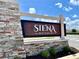 Entrance to Siena Reserve neighborhood featuring a decorative stone sign at 7 Polermo Ave, St Cloud, FL 34771