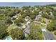 An aerial view of a residential neighborhood with mature trees, pools, and waterfront properties at 708 Valencia Ct, Winter Garden, FL 34787