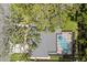 Aerial view of the house showcasing the gray roof and screened-in pool with a bright blue cover at 708 Valencia Ct, Winter Garden, FL 34787