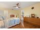 Bedroom with hardwood floors, ceiling fan, and access to the living spaces at 708 Valencia Ct, Winter Garden, FL 34787