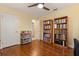 Bedroom with hardwood floors featuring book shelves and easy access to other rooms in the house at 708 Valencia Ct, Winter Garden, FL 34787