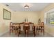 Cozy dining room featuring tile flooring, a large window, and ample space for hosting dinner parties at 708 Valencia Ct, Winter Garden, FL 34787