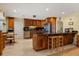 Spacious kitchen featuring beautiful wood cabinetry, stainless steel appliances, granite countertops and ample counter space at 708 Valencia Ct, Winter Garden, FL 34787