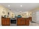 Open kitchen area featuring wood cabinetry, stainless steel oven, and views of the living space and backyard at 708 Valencia Ct, Winter Garden, FL 34787