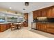 Bright kitchen with custom wood cabinetry, granite countertops, and stainless steel appliances overlooking the backyard at 708 Valencia Ct, Winter Garden, FL 34787