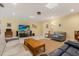 Spacious living room with a large TV, comfortable seating, and skylights for natural light at 708 Valencia Ct, Winter Garden, FL 34787