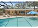 Relaxing backyard pool area with screened enclosure, lounge chairs, and a covered patio at 708 Valencia Ct, Winter Garden, FL 34787