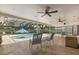 Backyard pool with screened-in enclosure, covered seating area, and lush landscaping at 708 Valencia Ct, Winter Garden, FL 34787