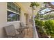 Covered front porch with comfortable seating, views of the neighborhood, and decorative plants that add charm at 708 Valencia Ct, Winter Garden, FL 34787