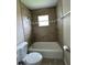Bathroom with a tiled shower and tub, tiled walls, and updated fixtures at 739 Parrot Ct, Poinciana, FL 34759