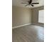 Bright bedroom with wood-look tile flooring, a ceiling fan, and a window at 739 Parrot Ct, Poinciana, FL 34759