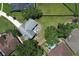 Aerial view of the home's backyard showing a lovely patio with furniture and a generous lawn area at 759 Lake Como Dr, Lake Mary, FL 32746