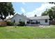 Spacious green backyard with patio seating and view of home's exterior, perfect for outdoor enjoyment at 759 Lake Como Dr, Lake Mary, FL 32746