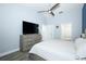 Spacious bedroom with a large television, ceiling fan, and ensuite bathroom at 759 Lake Como Dr, Lake Mary, FL 32746