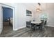 Elegant dining area with modern lighting, grey chairs and connection to the bedroom at 759 Lake Como Dr, Lake Mary, FL 32746