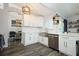 Modern kitchen featuring white cabinets, stainless appliances, and decorative wooden shelving at 759 Lake Como Dr, Lake Mary, FL 32746