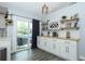 Bright kitchenette includes white cabinets, wood counters, and access to the outdoor patio at 759 Lake Como Dr, Lake Mary, FL 32746