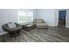 Bright living room with large windows, comfortable seating, and stylish decor at 759 Lake Como Dr, Lake Mary, FL 32746