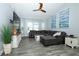 Bright open living room with gray flooring, ceiling fan and modern coastal-themed decor at 759 Lake Como Dr, Lake Mary, FL 32746