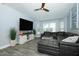 Living room with wide screen tv, modern floors, and comfortable sectional seating at 759 Lake Como Dr, Lake Mary, FL 32746