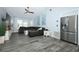 Bright living room with modern flooring, stainless steel fridge, and a comfortable sectional sofa at 759 Lake Como Dr, Lake Mary, FL 32746