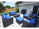 Back patio showing elegant black wicker seating set with bright blue cushions and gray pavers at 759 Lake Como Dr, Lake Mary, FL 32746