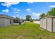 An expansive backyard features a shed, with an enclosed porch, perfect for outdoor enjoyment at 845 Valnera Ct, Kissimmee, FL 34758