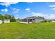 Large backyard featuring lush green grass and a shed with screened-in porch area at 845 Valnera Ct, Kissimmee, FL 34758