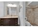 Bathroom featuring vanity with marble countertop, a mirror, and a tiled shower with glass doors at 845 Valnera Ct, Kissimmee, FL 34758