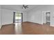 Bright bedroom with hardwood floors, vaulted ceiling, and sliding glass doors to outdoor patio at 845 Valnera Ct, Kissimmee, FL 34758