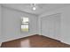 A bright bedroom features a window, ceiling fan, and a closet with bi-fold doors at 845 Valnera Ct, Kissimmee, FL 34758