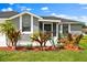 Home with well-manicured lawn and lush landscaping around the front of the property at 845 Valnera Ct, Kissimmee, FL 34758
