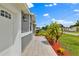 Exterior of the home with a tiled walkway and freshly mulched garden at 845 Valnera Ct, Kissimmee, FL 34758