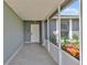 Inviting covered front porch with tiled floor and decorative landscaping, enhancing curb appeal at 845 Valnera Ct, Kissimmee, FL 34758