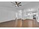 Open-concept living room with hardwood floors, vaulted ceilings, and seamless flow into dining area at 845 Valnera Ct, Kissimmee, FL 34758