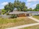 Aerial view of a charming single-story home with fenced yard, mature trees and a private driveway at 879 Tamerlane St, Deltona, FL 32725