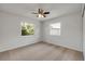 Bedroom featuring neutral carpet, a ceiling fan, and two windows with natural light at 879 Tamerlane St, Deltona, FL 32725