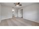 Bedroom with neutral carpet, a ceiling fan, and doors to a bathroom and closet at 879 Tamerlane St, Deltona, FL 32725