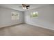 Bedroom featuring neutral carpet, a ceiling fan, and two windows with natural light at 879 Tamerlane St, Deltona, FL 32725