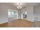 Inviting dining area showcasing tile flooring, decorative chandelier, and views into the living room and kitchen at 879 Tamerlane St, Deltona, FL 32725