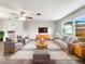 Bright living room boasts modern furniture, natural light and neutral walls, creating a welcoming atmosphere at 879 Tamerlane St, Deltona, FL 32725