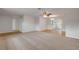 Open living area with carpet, neutral walls, ceiling fan, and access to both the dining and kitchen spaces at 879 Tamerlane St, Deltona, FL 32725