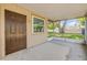 Covered screened porch with view of yard, concrete floor and an exterior door to the home at 879 Tamerlane St, Deltona, FL 32725