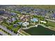 Aerial view showcasing community amenities: pools, playgrounds, clubhouse, parking, and lush landscaping at 8951 Hilton Ridge Ave, Kissimmee, FL 34747