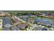 An aerial image showing a community layout complete with lakes, streets and residential houses at 8951 Hilton Ridge Ave, Kissimmee, FL 34747