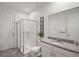 A clean, well-lit bathroom with a glass-enclosed shower, vanity, and neutral finishes at 8951 Hilton Ridge Ave, Kissimmee, FL 34747
