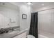 A bright bathroom featuring a single sink vanity, shower-tub combo, and framed art at 8951 Hilton Ridge Ave, Kissimmee, FL 34747